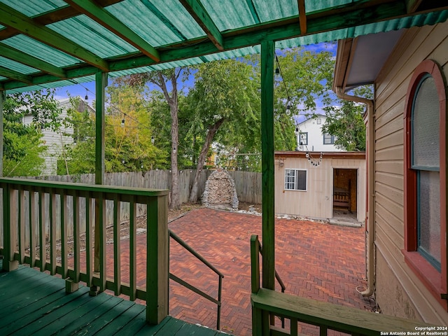 deck featuring an outbuilding and a patio