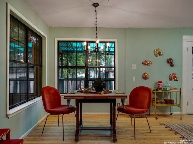 dining area with a notable chandelier and hardwood / wood-style flooring