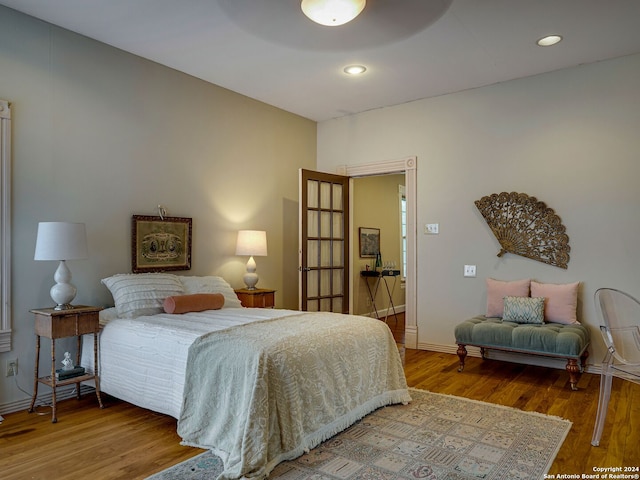 bedroom with hardwood / wood-style floors and ceiling fan