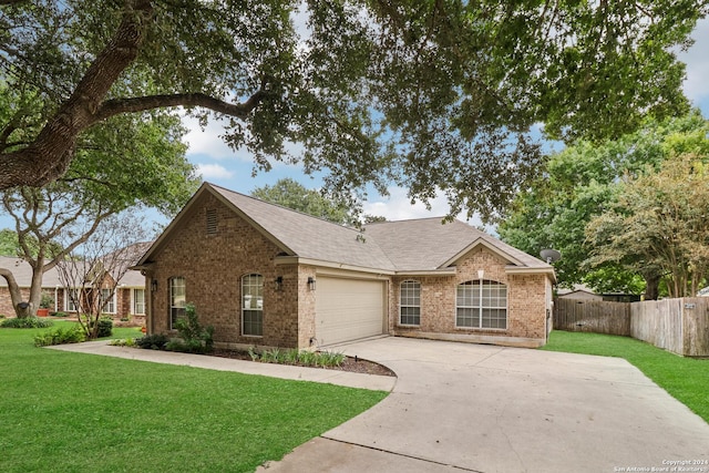 ranch-style house featuring concrete driveway, fence, brick siding, a front lawn, and a garage