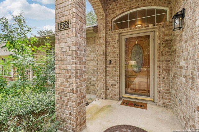 property entrance with brick siding