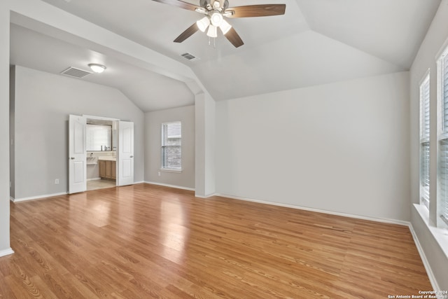 unfurnished living room featuring light hardwood / wood-style flooring, ceiling fan, and vaulted ceiling