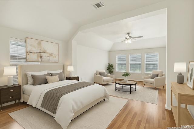 bedroom featuring visible vents, wood finished floors, multiple windows, and lofted ceiling