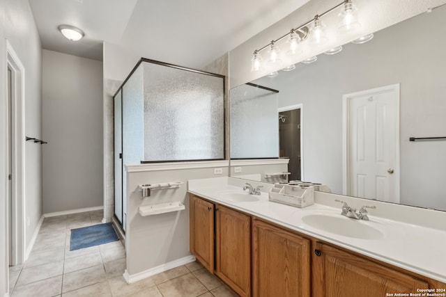 bathroom with vanity, a shower with shower door, and tile patterned flooring