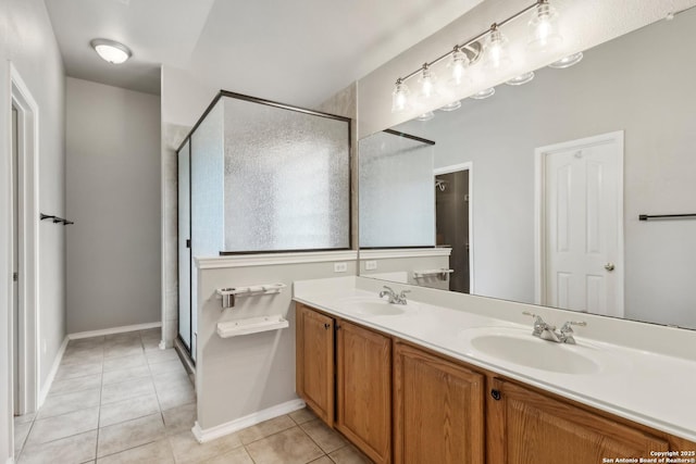 full bathroom with tile patterned floors, double vanity, a stall shower, and a sink