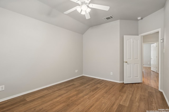 empty room featuring wood-type flooring, vaulted ceiling, and ceiling fan