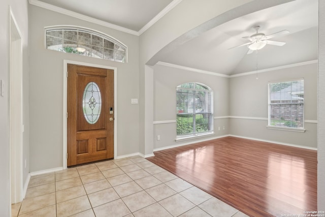 foyer featuring crown molding, light hardwood / wood-style flooring, vaulted ceiling, and ceiling fan