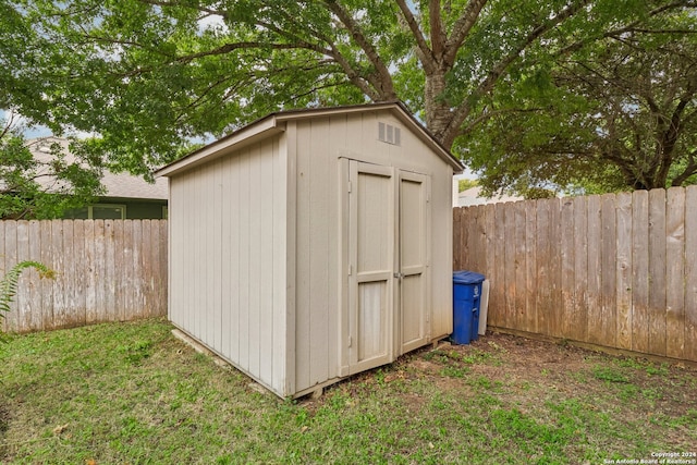 view of outdoor structure featuring a lawn