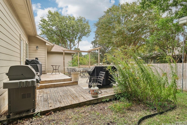 wooden terrace with fence and area for grilling
