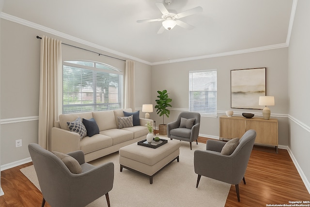 living room featuring crown molding, ceiling fan, wood finished floors, and baseboards
