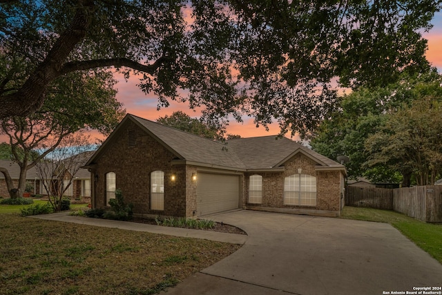 view of front of house featuring a yard and a garage