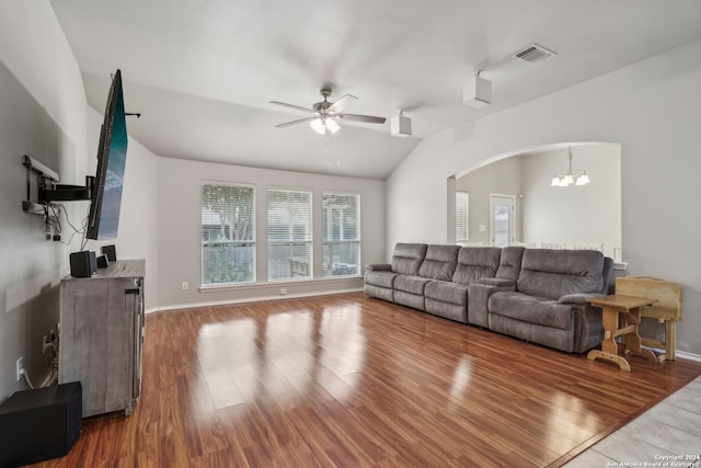 living room with lofted ceiling, wood-type flooring, and ceiling fan with notable chandelier