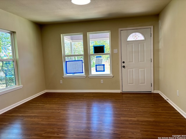 entrance foyer featuring a textured ceiling and dark wood-type flooring