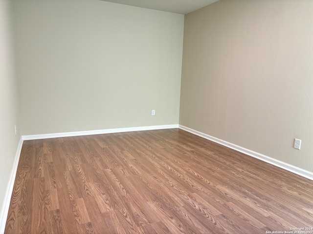 spare room featuring wood-type flooring