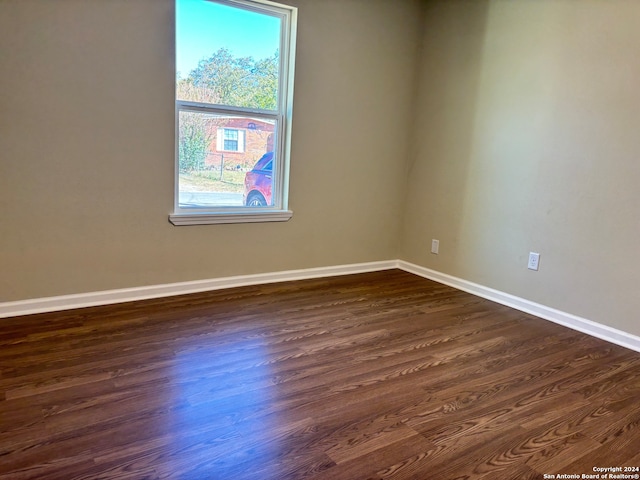 empty room featuring dark wood-type flooring