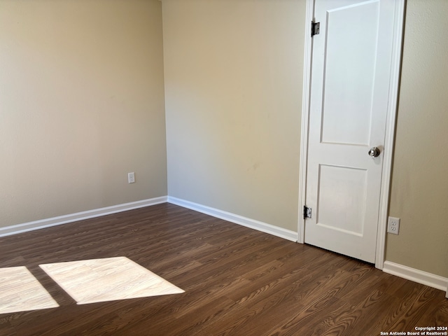 unfurnished room featuring dark hardwood / wood-style flooring