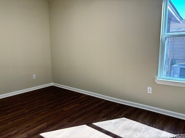 spare room with dark hardwood / wood-style flooring