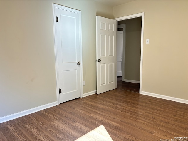 unfurnished bedroom featuring dark hardwood / wood-style floors