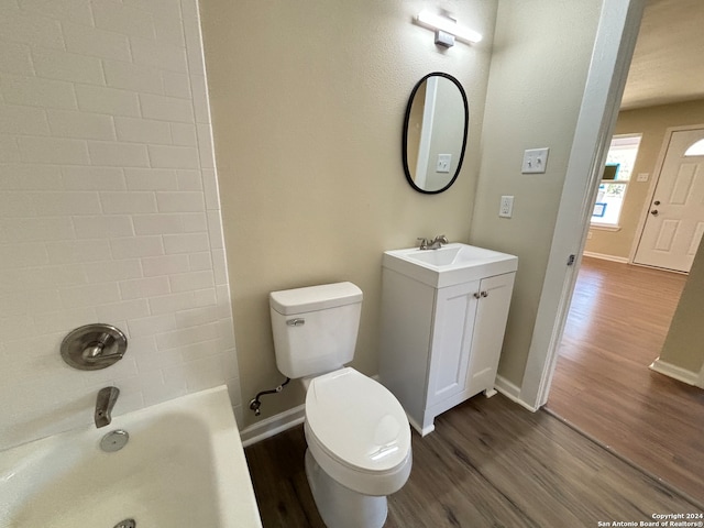 full bathroom featuring vanity, toilet, hardwood / wood-style flooring, and  shower combination