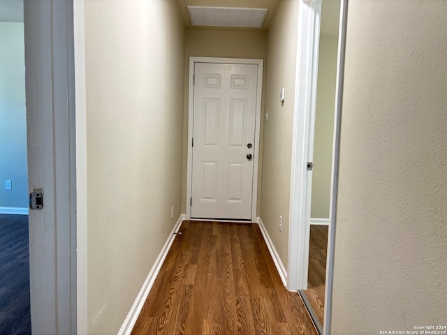 corridor with wood-type flooring