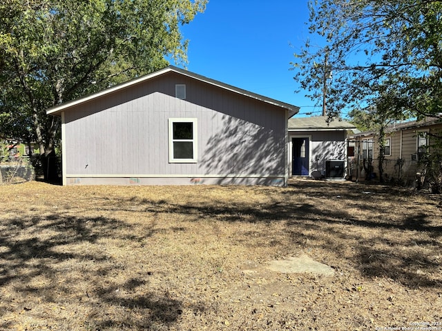 back of house with central AC unit