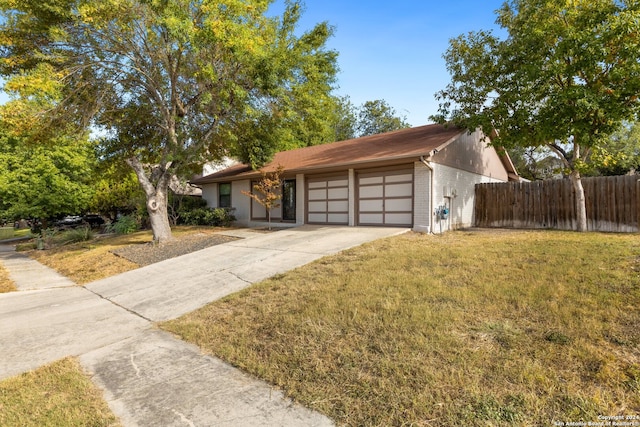 single story home featuring a front yard and a garage