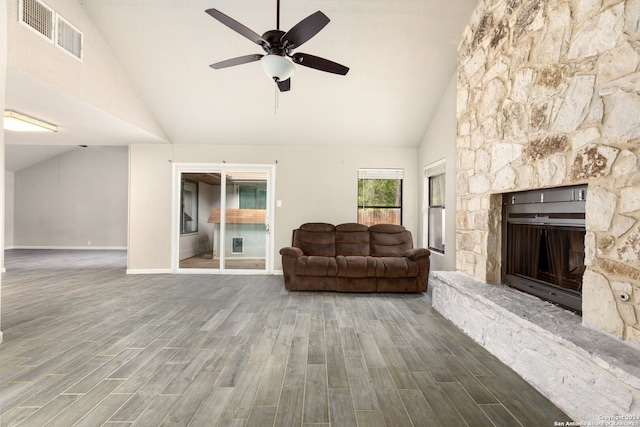 living room featuring hardwood / wood-style flooring, high vaulted ceiling, a fireplace, and ceiling fan