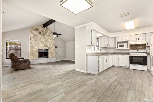 kitchen with white cabinetry, light hardwood / wood-style flooring, beamed ceiling, a fireplace, and white appliances