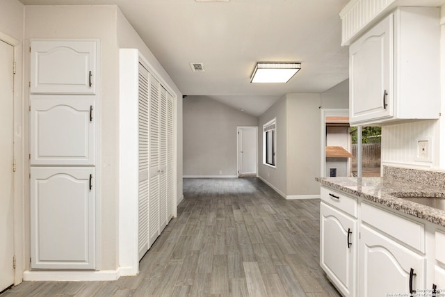 hall with light hardwood / wood-style floors