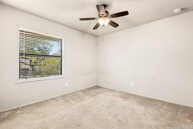 empty room featuring light carpet and ceiling fan