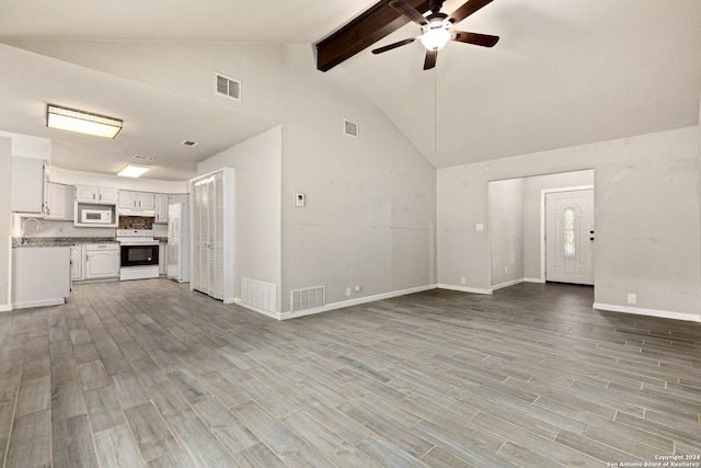 unfurnished living room featuring beamed ceiling, high vaulted ceiling, light wood-type flooring, and ceiling fan