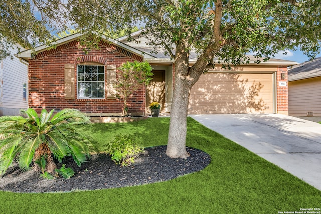 ranch-style house featuring a garage and a front yard