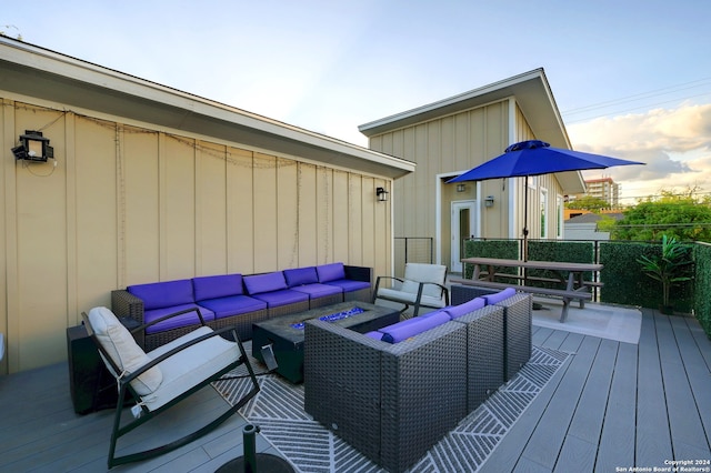 deck at dusk with outdoor lounge area