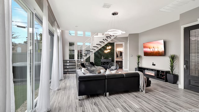 living room featuring light hardwood / wood-style floors and a notable chandelier