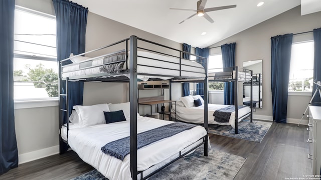 bedroom featuring lofted ceiling, multiple windows, dark hardwood / wood-style floors, and ceiling fan