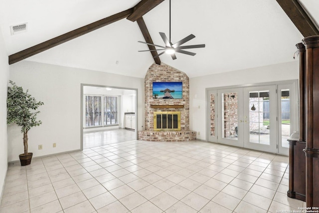 unfurnished living room with beam ceiling, ceiling fan, french doors, high vaulted ceiling, and a fireplace