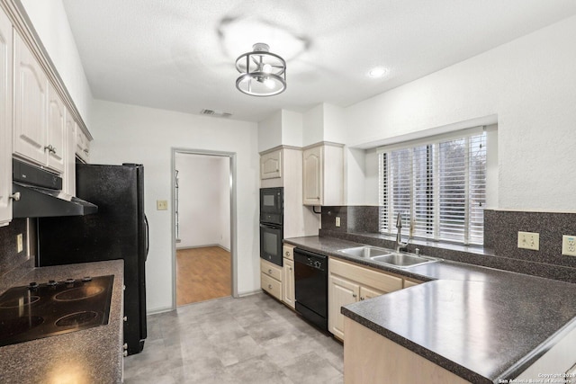 kitchen featuring sink, tasteful backsplash, kitchen peninsula, a textured ceiling, and black appliances