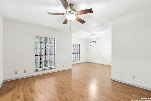 unfurnished living room with ceiling fan, wood-type flooring, and a textured ceiling