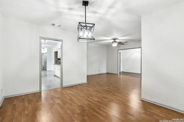 interior space with ceiling fan, wood-type flooring, and a textured ceiling