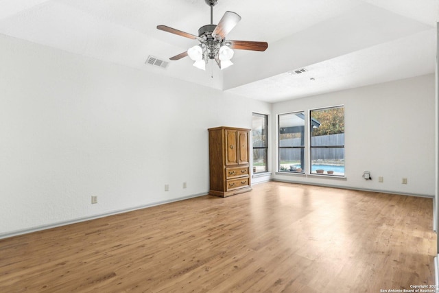 unfurnished living room featuring ceiling fan and light wood-type flooring