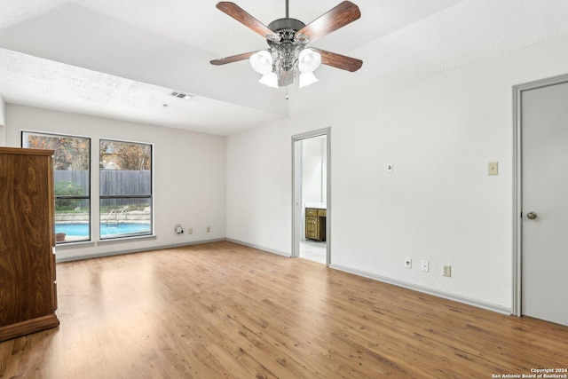 unfurnished room featuring ceiling fan, a textured ceiling, and light hardwood / wood-style flooring