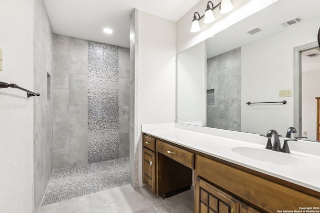 bathroom featuring tile patterned floors, vanity, and tiled shower