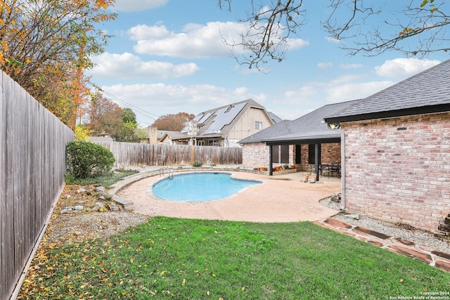 view of swimming pool featuring a lawn and a patio