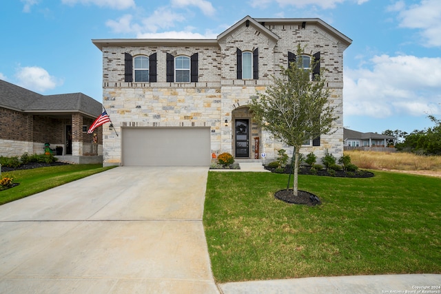 view of front facade with a front yard and a garage