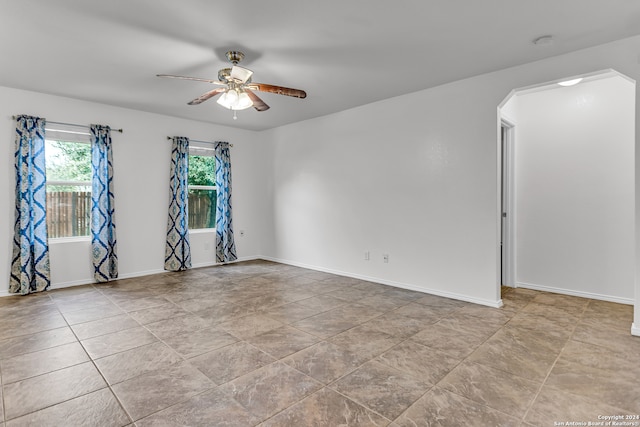 unfurnished room with ceiling fan