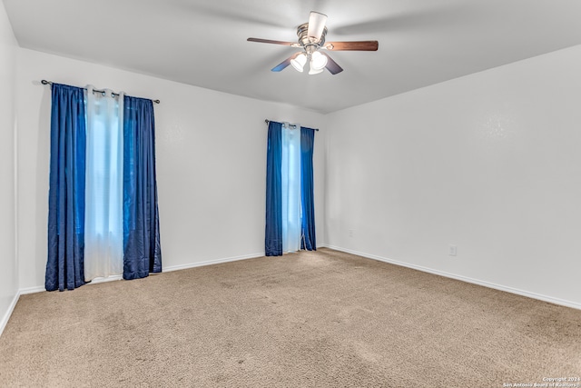 unfurnished room with ceiling fan and carpet flooring