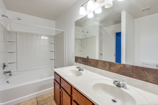 full bathroom featuring toilet, tiled shower / bath, vanity, and tile patterned flooring