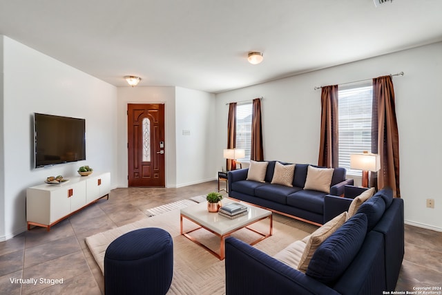 tiled living room featuring a wealth of natural light