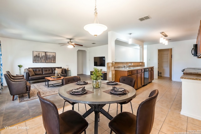 dining space featuring sink, light tile patterned floors, and ceiling fan