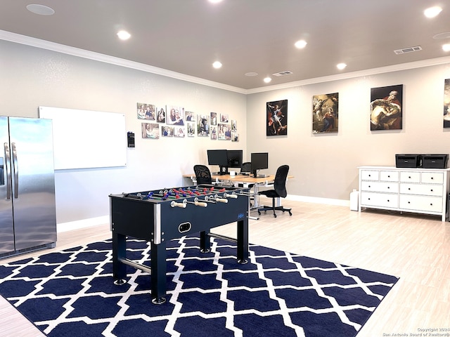 rec room with wood-type flooring and crown molding